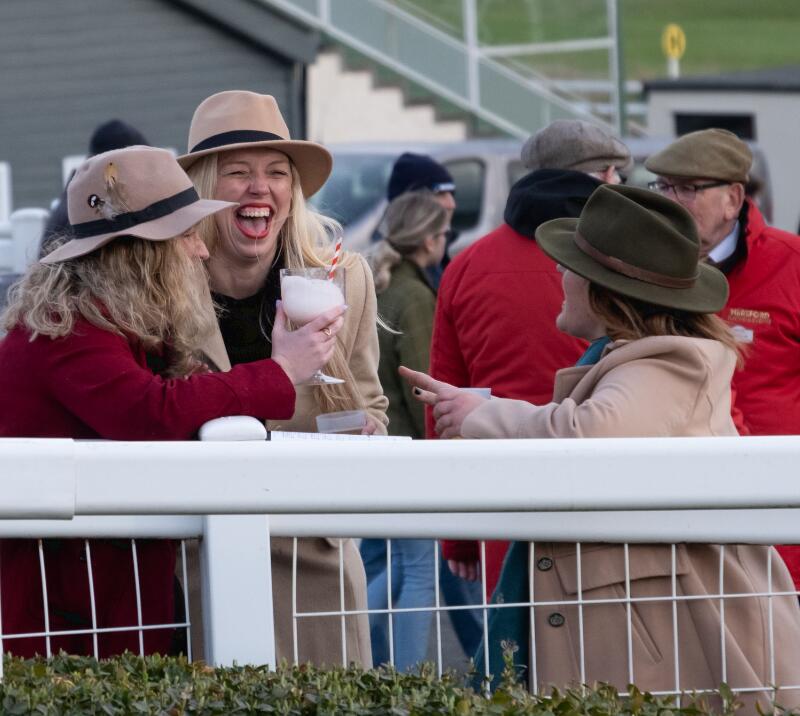 A group of friends share a laugh at the track side at Hereford Races