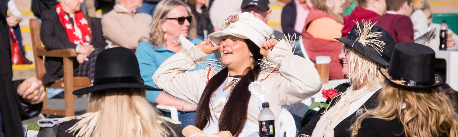 A bride to be, complete with hat, sash and badge, enjoying herself at Hereford Races