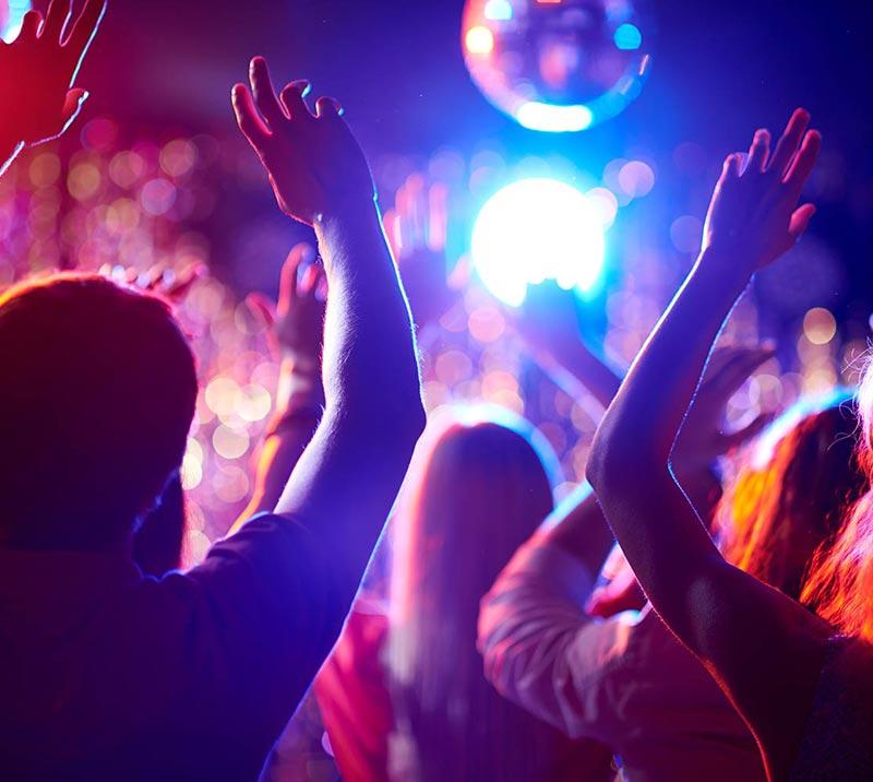 Crowd of people dancing at a party.