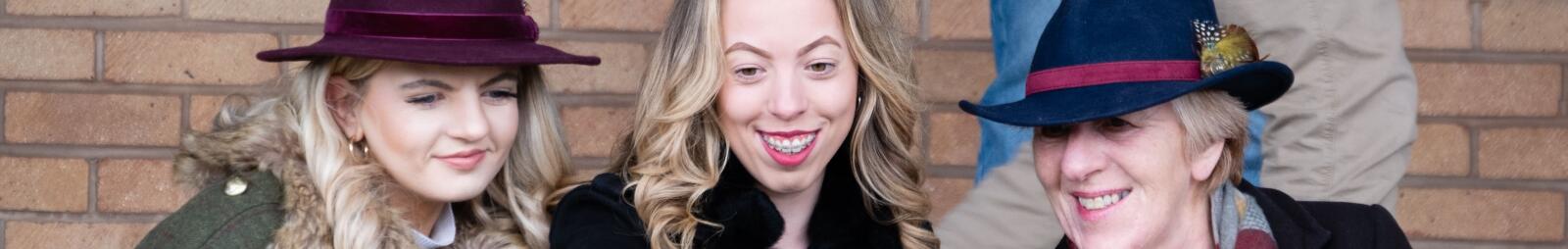 A small group of ladies dressed for winter racing taking a selfie
