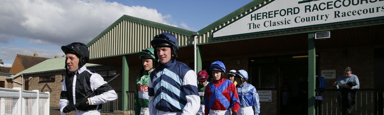 Jockeys at Hereford Racecourse prepare for horse racing